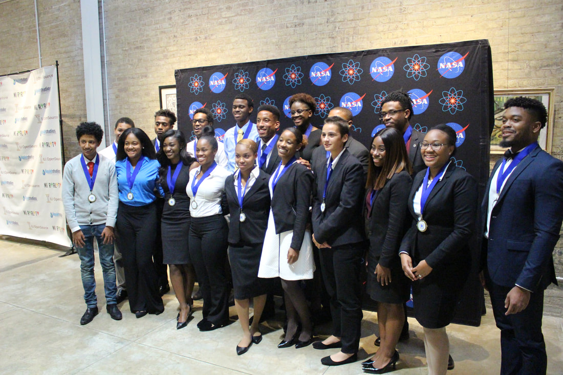 Medal-winning students posing together before the NASA Technology Transfer backdrop