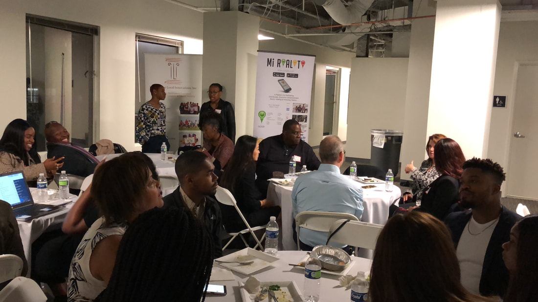 Participants attending a workshop in a bright meeting room with round tables