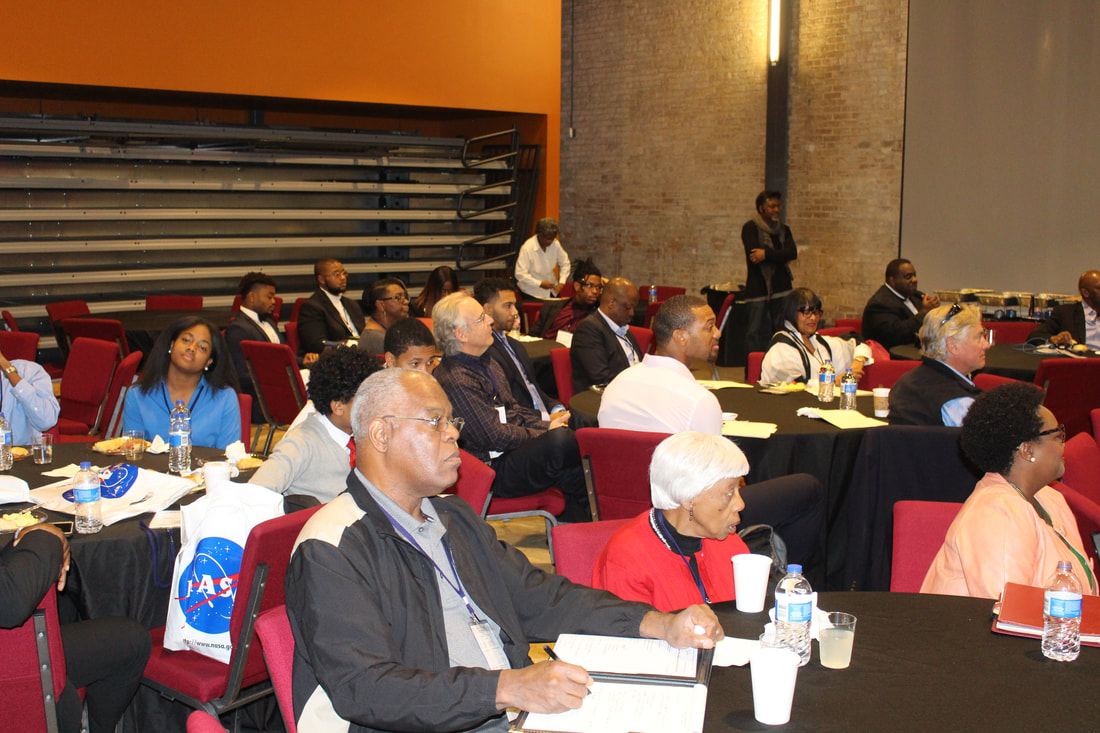 TIME Challenge audience seated at round tables in the auditorium