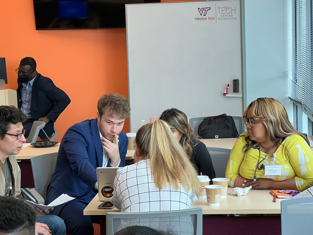 Participants leaning over their notes during a group workshop exercise