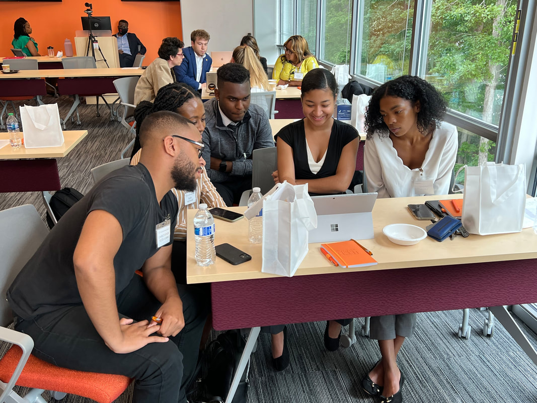 Small workshop group reviewing material together on a laptop