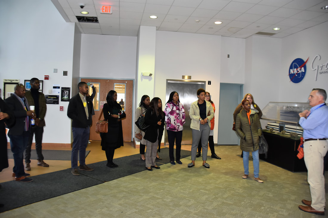 Visitors gathered for a tour inside a NASA exhibit area