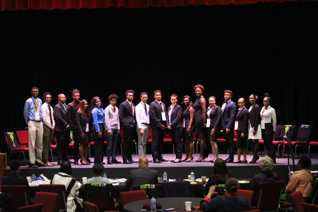 Student teams standing together on stage after TIME Challenge presentations