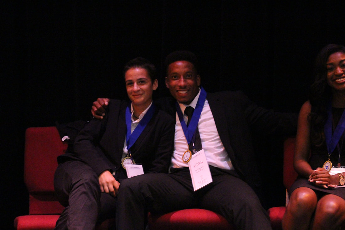 Two medal recipients seated together during the TIME Challenge awards ceremony