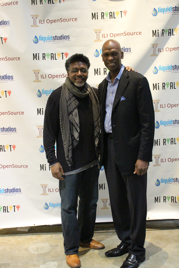 Two event participants posing together before the OpenSOURCE backdrop