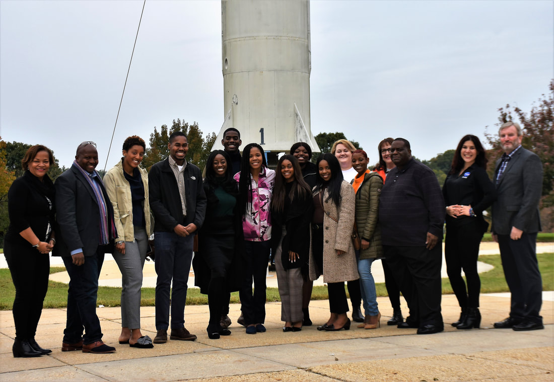 TIME Challenge participants posing outdoors beside a large concrete column
