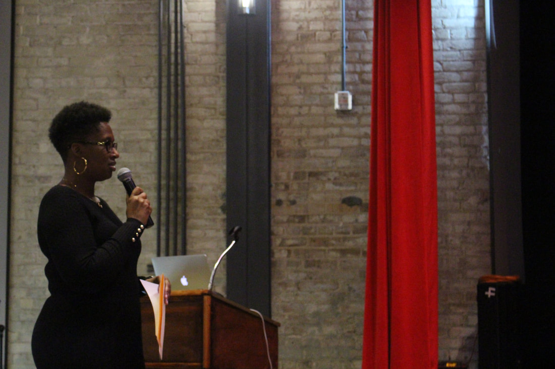 Student addressing the audience beside the podium during the interview session