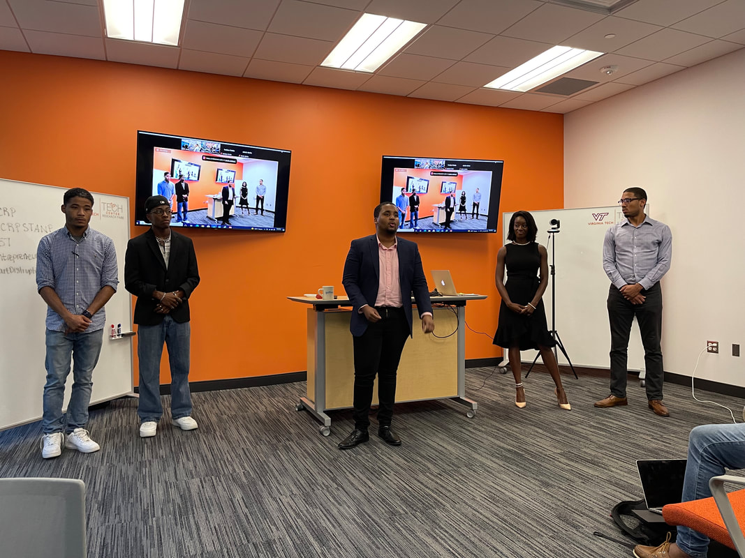 Five participants standing at the front of the workshop room for introductions