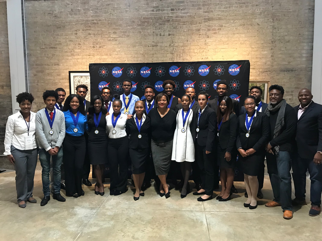 TIME Challenge participants and organizers posing together before the NASA event backdrop