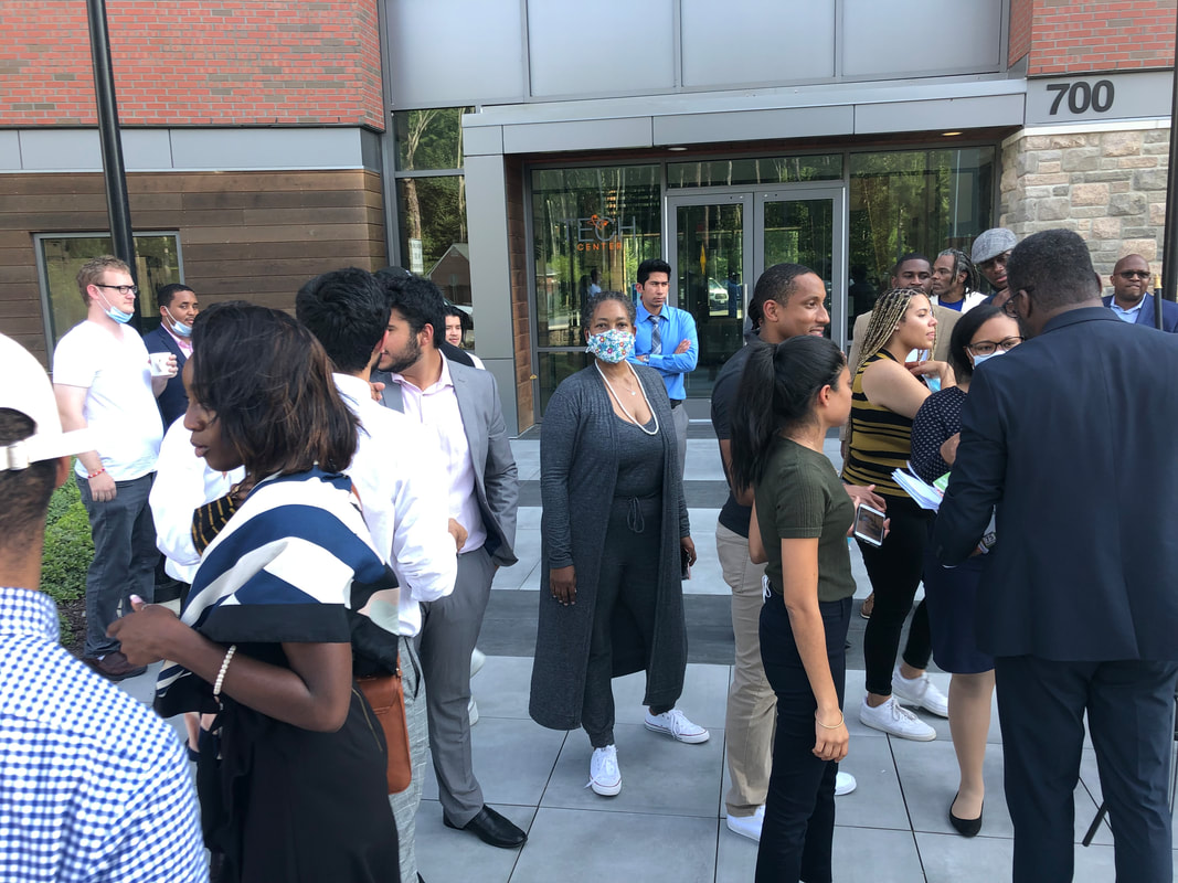 Participants greeting one another outside the Tech Center entrance