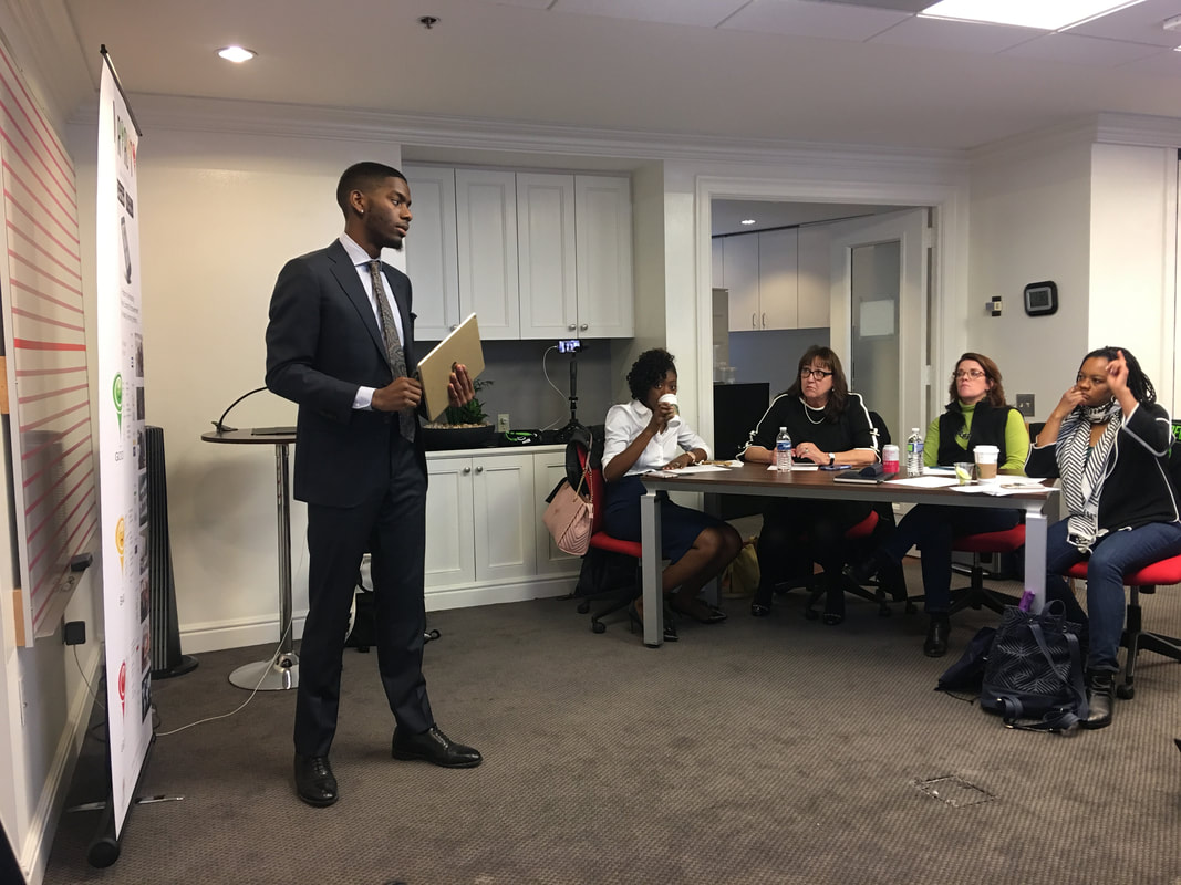 Presenter holding notes while addressing participants in a meeting room