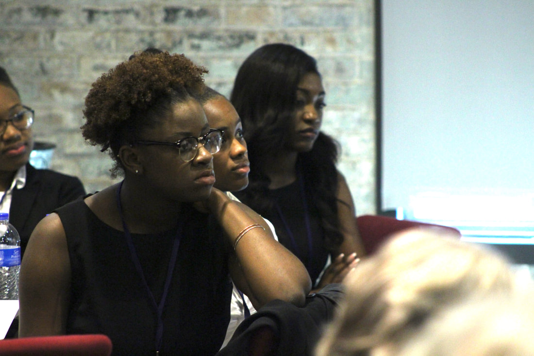 Audience members listening closely during a TIME Challenge presentation