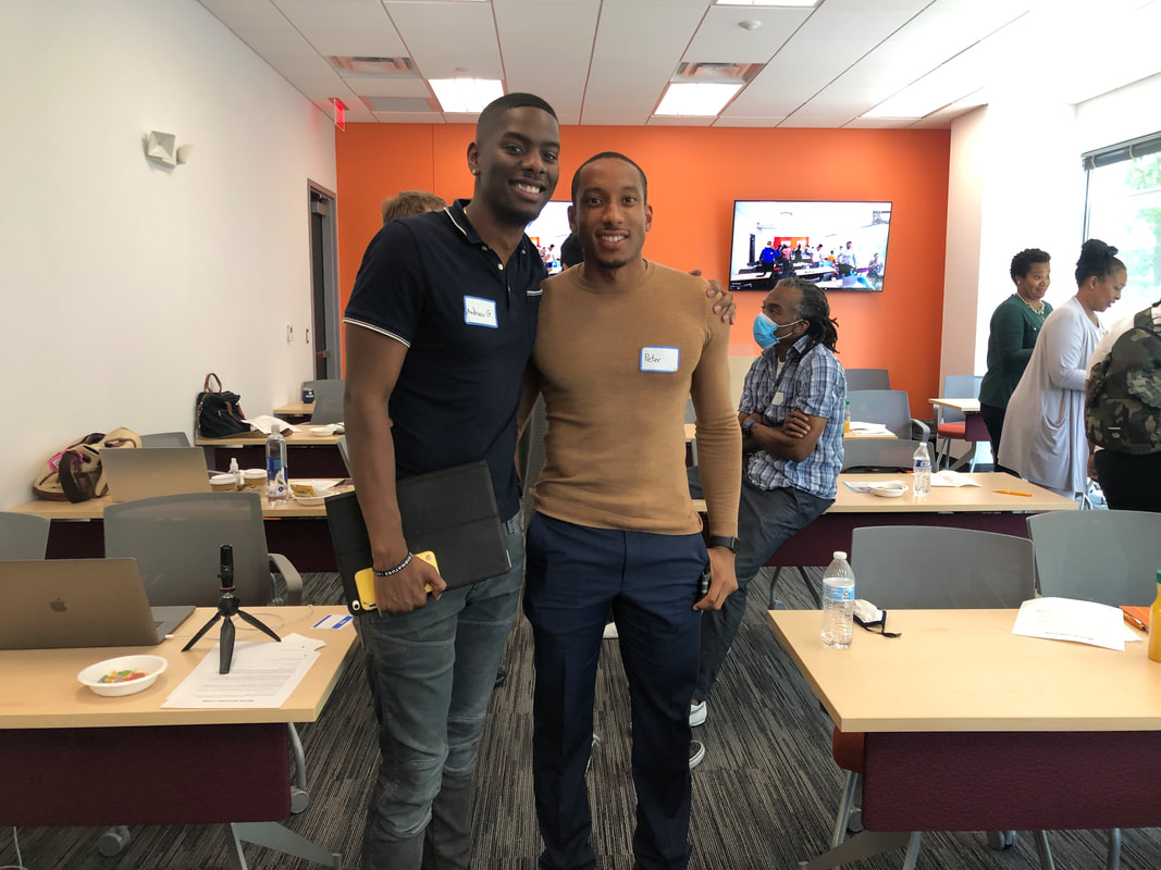 Two workshop participants posing together in the Tech Center meeting room